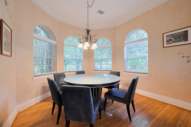 3665 Maranatha Dr, Sugar Land, TX 77479 - dining area featuring light wood-type flooring, a chandelier, and ornamental molding