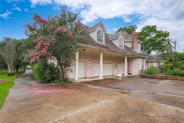 3665 Maranatha Dr, Sugar Land, TX 77479 - view of side of home with concrete driveway, a chimney, and brick siding
