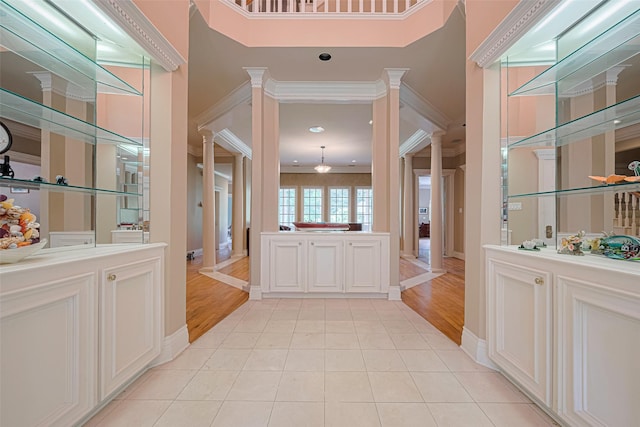 3665 Maranatha Dr, Sugar Land, TX 77479 - entryway with ornate columns, ornamental molding, and light tile patterned floors