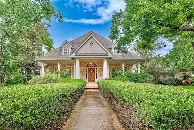 3665 Maranatha Dr, Sugar Land, TX 77479 - view of front of house featuring brick siding, roof with shingles, and a porch