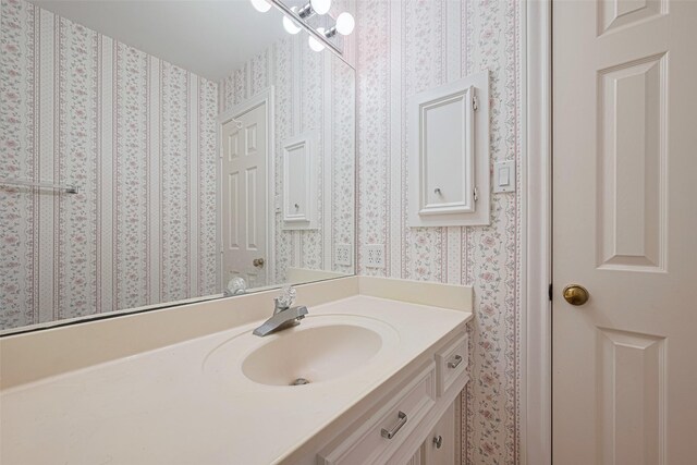 3665 Maranatha Dr, Sugar Land, TX 77479 - bathroom with wallpapered walls and vanity