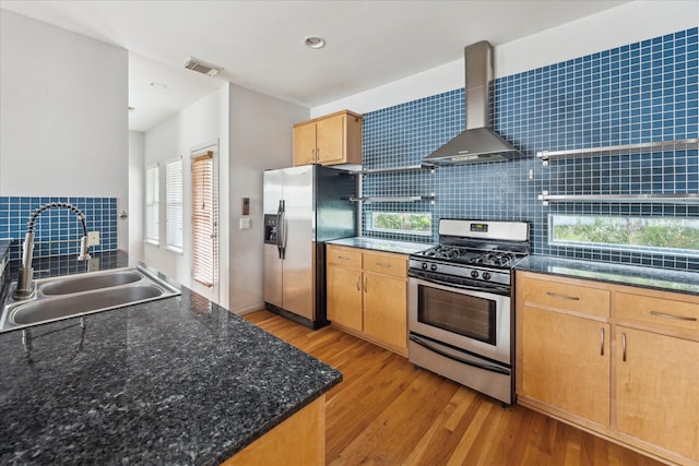 5219 Kiam St Unit F, Houston, TX 77007 - kitchen featuring stainless steel appliances, wall chimney range hood, tasteful backsplash, light wood-style flooring, and recessed lighting