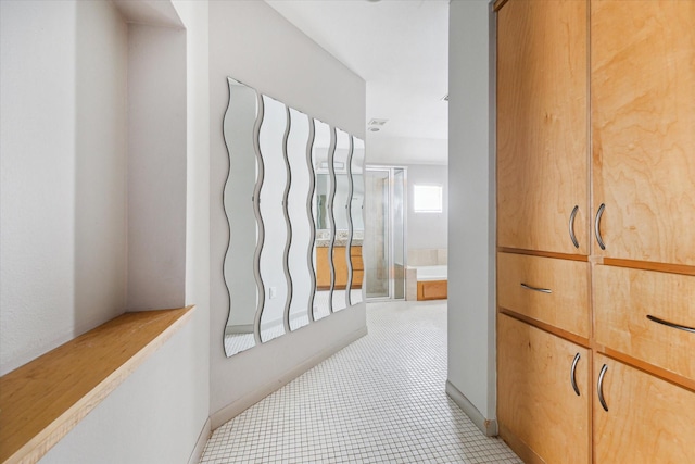 5219 Kiam St Unit F, Houston, TX 77007 - hallway featuring light tile patterned flooring and light carpet