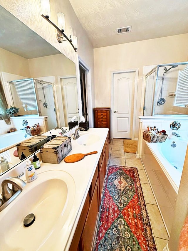 8010 N Tarrytown Crossing Dr, Conroe, TX 77304 - full bathroom with a stall shower, a bath, tile patterned flooring, double vanity, and a textured ceiling