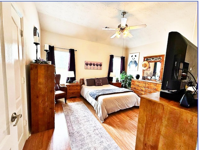 8010 N Tarrytown Crossing Dr, Conroe, TX 77304 - bedroom with light wood-type flooring and a ceiling fan