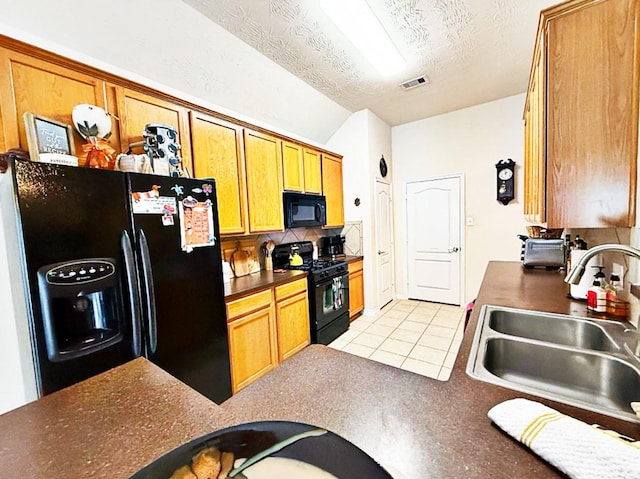 8010 N Tarrytown Crossing Dr, Conroe, TX 77304 - kitchen featuring black appliances, backsplash, light tile patterned flooring, dark countertops, and lofted ceiling