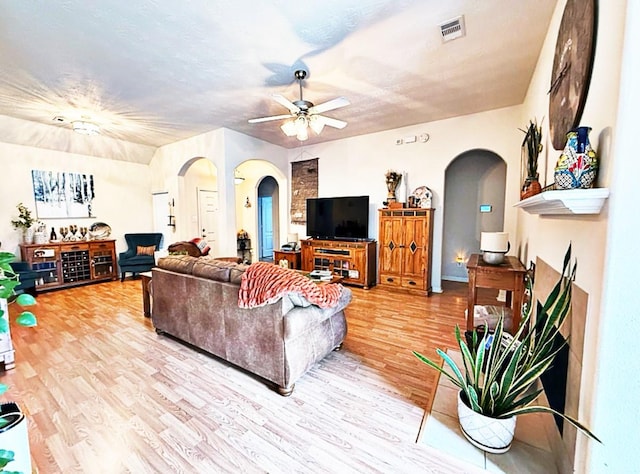 8010 N Tarrytown Crossing Dr, Conroe, TX 77304 - living area with arched walkways, light wood-type flooring, and ceiling fan