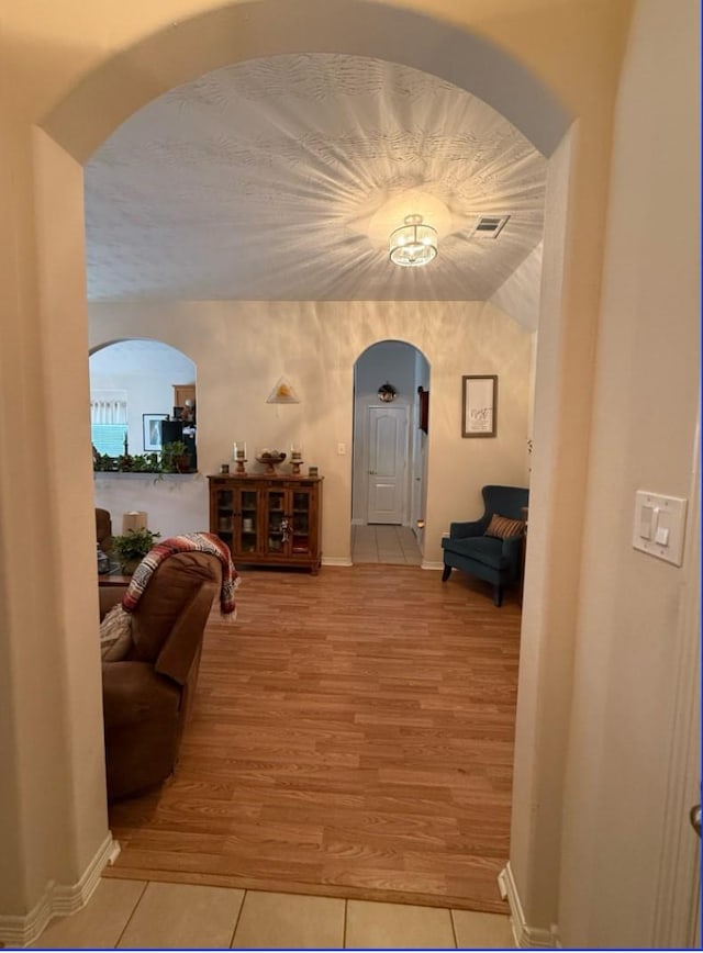 8010 N Tarrytown Crossing Dr, Conroe, TX 77304 - corridor with arched walkways and light tile patterned flooring