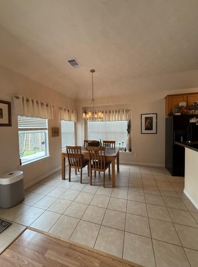 8010 N Tarrytown Crossing Dr, Conroe, TX 77304 - dining area featuring a chandelier and light tile patterned flooring