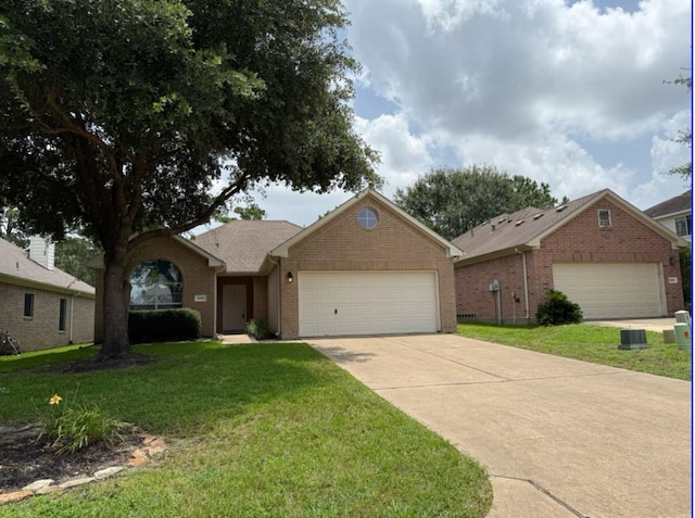 8010 N Tarrytown Crossing Dr, Conroe, TX 77304 - ranch-style home featuring brick siding, an attached garage, driveway, and a front lawn