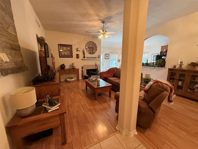 8010 N Tarrytown Crossing Dr, Conroe, TX 77304 - living area with arched walkways, light wood-style flooring, and ceiling fan