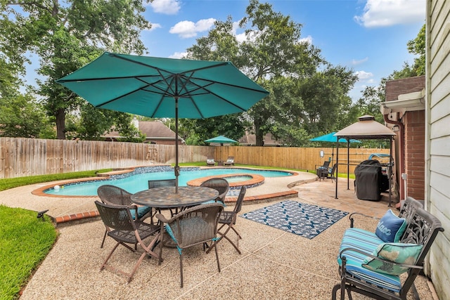 19318 Kristen Pine Dr, Humble, TX 77346 - view of swimming pool with a gazebo, a hot tub, a patio area, and a fenced backyard