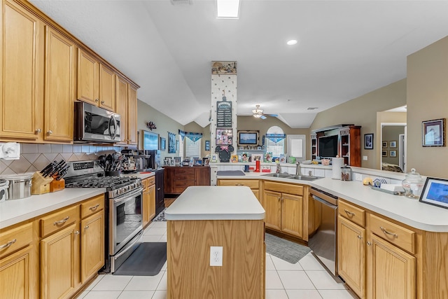 19318 Kristen Pine Dr, Humble, TX 77346 - kitchen with stainless steel appliances, a center island, lofted ceiling, ceiling fan, and decorative backsplash
