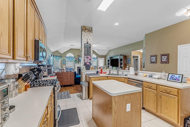 19318 Kristen Pine Dr, Humble, TX 77346 - kitchen featuring a kitchen island, open floor plan, appliances with stainless steel finishes, vaulted ceiling, and light countertops