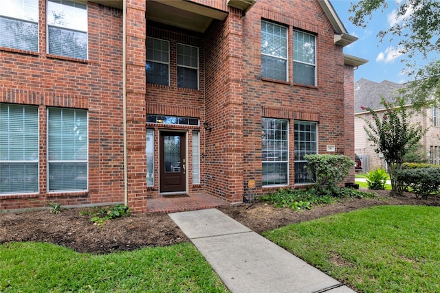 216 Willow Pointe Dr, League City, TX 77573 - doorway to property featuring brick siding and a lawn
