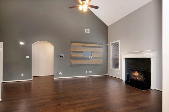 216 Willow Pointe Dr, League City, TX 77573 - unfurnished living room with high vaulted ceiling, ceiling fan, a high end fireplace, arched walkways, and wood finished floors