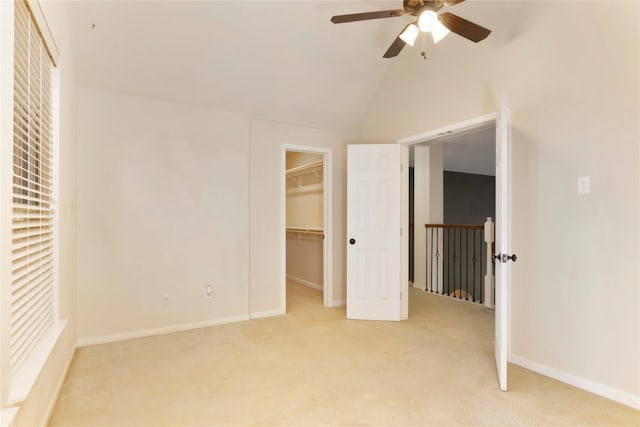 216 Willow Pointe Dr, League City, TX 77573 - unfurnished bedroom with light carpet, a spacious closet, vaulted ceiling, and a ceiling fan