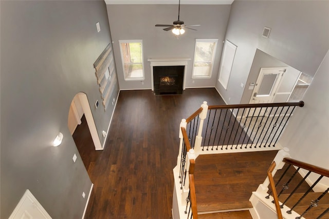 216 Willow Pointe Dr, League City, TX 77573 - stairs featuring a high ceiling, ceiling fan, a fireplace with flush hearth, and wood finished floors