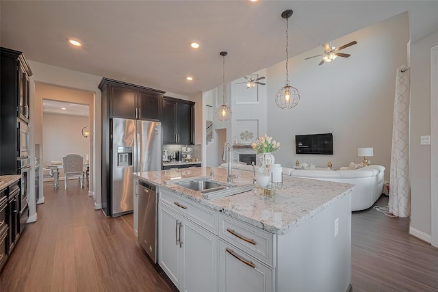 11527 Taagan Ln, Richmond, TX 77407 - kitchen featuring a ceiling fan, appliances with stainless steel finishes, dark wood-type flooring, open floor plan, and recessed lighting