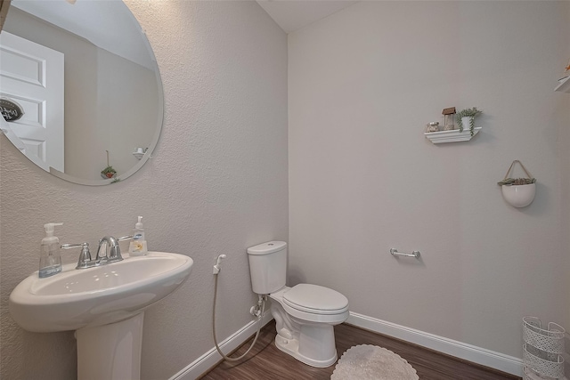 11527 Taagan Ln, Richmond, TX 77407 - bathroom featuring wood finished floors and toilet