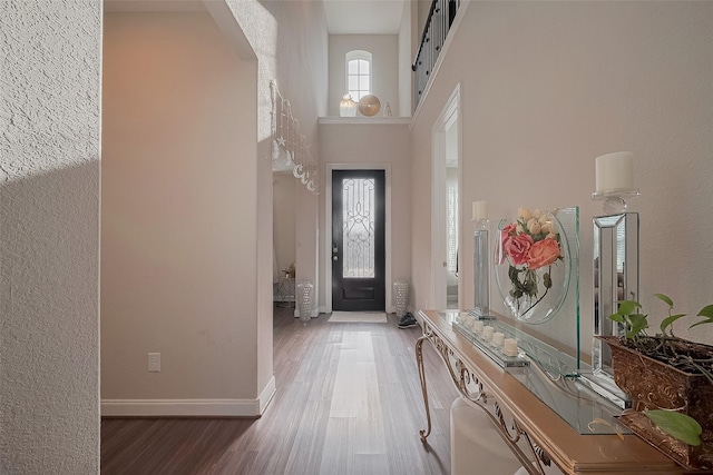 11527 Taagan Ln, Richmond, TX 77407 - entryway featuring wood finished floors, a towering ceiling, and arched walkways