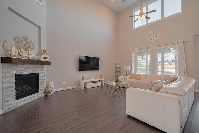 11527 Taagan Ln, Richmond, TX 77407 - living area featuring a towering ceiling, a ceiling fan, plenty of natural light, dark wood-style floors, and a fireplace