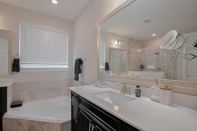 11527 Taagan Ln, Richmond, TX 77407 - bathroom with vanity, a bath, a stall shower, and recessed lighting