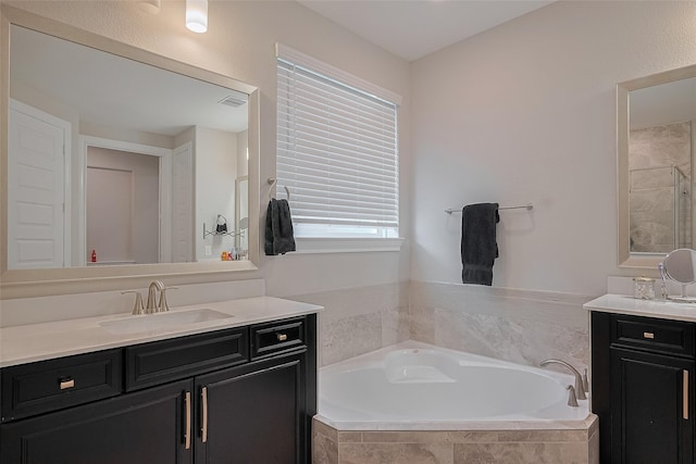 11527 Taagan Ln, Richmond, TX 77407 - full bathroom with vanity, a garden tub, and a stall shower