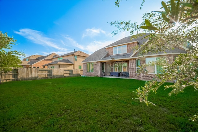 11527 Taagan Ln, Richmond, TX 77407 - back of house with a fenced backyard, brick siding, and a patio