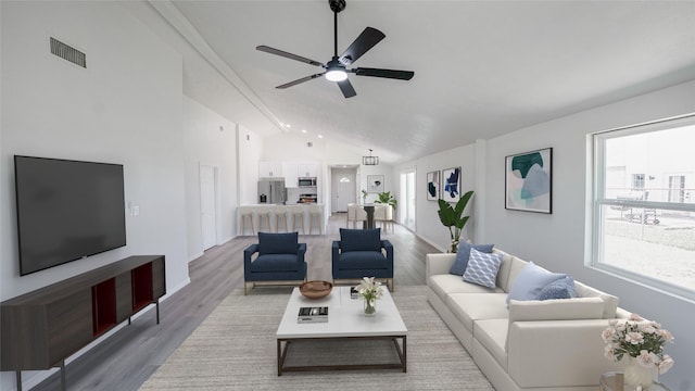14223 Edenglen Dr, Houston, TX 77049 - living room featuring vaulted ceiling, a ceiling fan, light wood-type flooring, and healthy amount of natural light