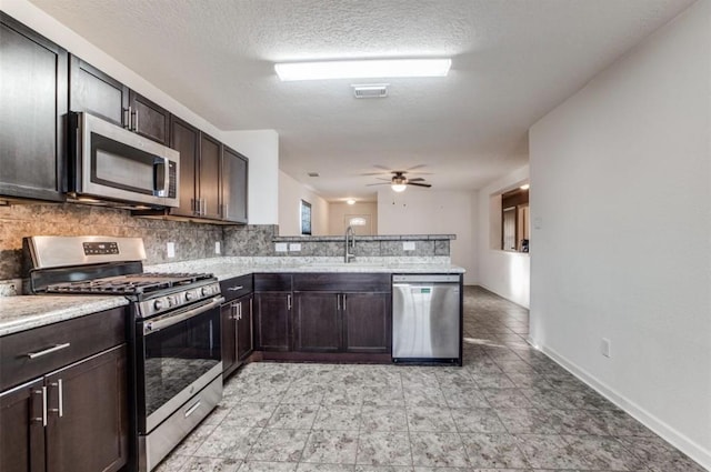 19346 Bold River Rd, Tomball, TX 77375 - kitchen featuring stainless steel appliances, backsplash, a peninsula, a ceiling fan, and dark brown cabinetry