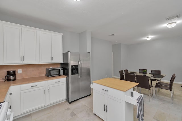 5822 Santa Bernadetta, Houston, TX 77017 - kitchen with appliances with stainless steel finishes, butcher block countertops, and white cabinets