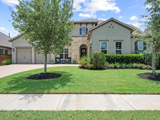 10814 Avery Arbor Ln, Cypress, TX 77433 - view of front of property with stucco siding, concrete driveway, a front yard, stone siding, and a garage