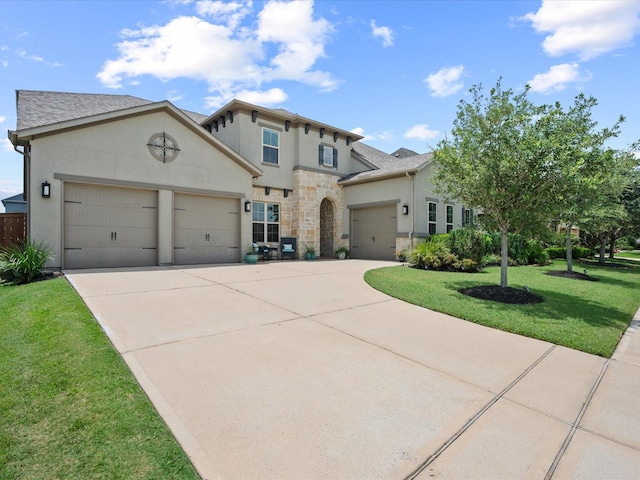 10814 Avery Arbor Ln, Cypress, TX 77433 - view of front of property with stucco siding, a garage, driveway, and a front lawn