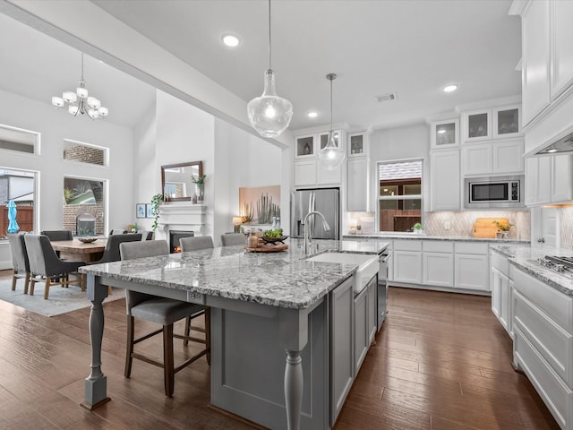10814 Avery Arbor Ln, Cypress, TX 77433 - kitchen with stainless steel appliances, recessed lighting, backsplash, healthy amount of natural light, and white cabinets