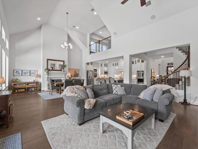 10814 Avery Arbor Ln, Cypress, TX 77433 - living area with high vaulted ceiling, stairway, ceiling fan, dark wood finished floors, and a chandelier