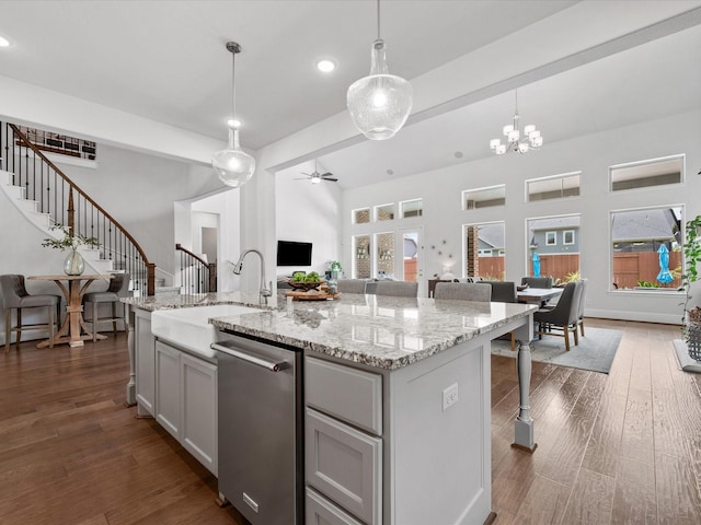 10814 Avery Arbor Ln, Cypress, TX 77433 - kitchen featuring open floor plan, stainless steel dishwasher, a kitchen breakfast bar, pendant lighting, and a kitchen island with sink