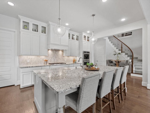 10814 Avery Arbor Ln, Cypress, TX 77433 - kitchen featuring stainless steel appliances, recessed lighting, tasteful backsplash, dark wood-style flooring, and a center island with sink