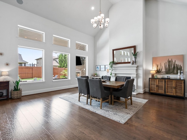 10814 Avery Arbor Ln, Cypress, TX 77433 - dining area with a fireplace, high vaulted ceiling, a chandelier, and hardwood / wood-style flooring
