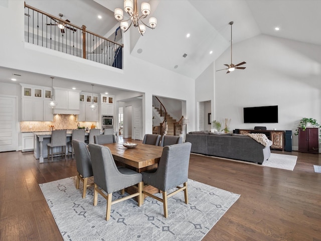 10814 Avery Arbor Ln, Cypress, TX 77433 - dining space with ceiling fan, stairway, high vaulted ceiling, recessed lighting, and dark wood finished floors