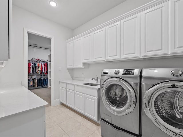 10814 Avery Arbor Ln, Cypress, TX 77433 - laundry area featuring separate washer and dryer, cabinet space, light tile patterned floors, and recessed lighting