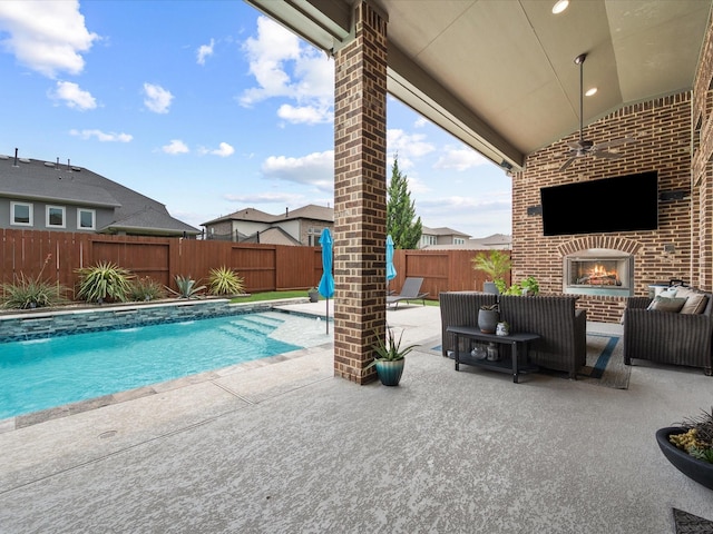 10814 Avery Arbor Ln, Cypress, TX 77433 - view of pool featuring a patio area, a fenced backyard, and an outdoor living space with a fireplace