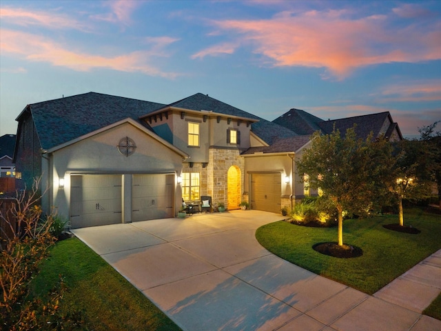 10814 Avery Arbor Ln, Cypress, TX 77433 - mediterranean / spanish home featuring stucco siding, a garage, driveway, stone siding, and a yard