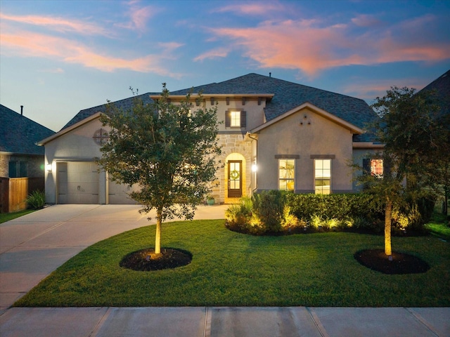 10814 Avery Arbor Ln, Cypress, TX 77433 - view of front of house featuring concrete driveway, a lawn, stucco siding, a garage, and stone siding