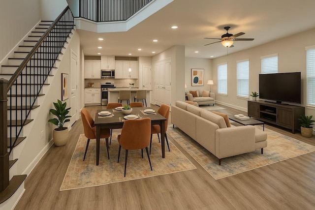 4301 Clover St, Houston, TX 77051 - dining room featuring wood finished floors, a ceiling fan, recessed lighting, and stairs
