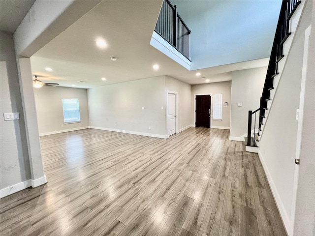 4301 Clover St, Houston, TX 77051 - unfurnished living room with ceiling fan, wood finished floors, stairway, and recessed lighting