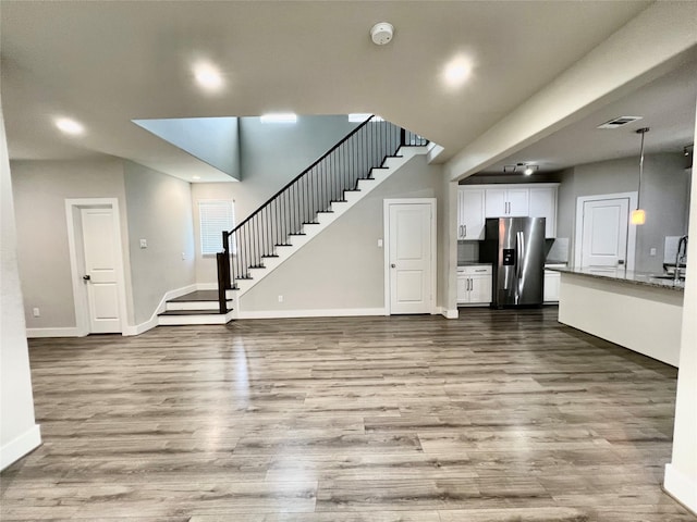 4301 Clover St, Houston, TX 77051 - unfurnished living room with stairs, dark wood finished floors, and recessed lighting