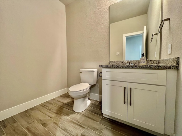 4301 Clover St, Houston, TX 77051 - bathroom featuring vanity, a textured wall, and wood finish floors