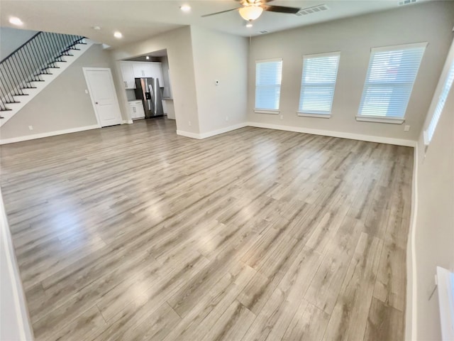 4301 Clover St, Houston, TX 77051 - unfurnished living room with a ceiling fan, wood finished floors, stairs, and recessed lighting