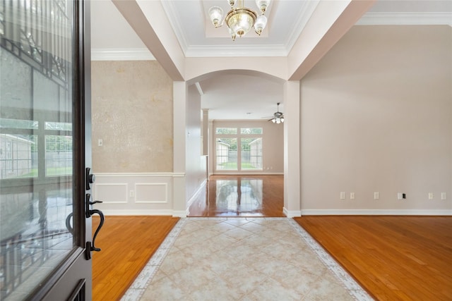 3102 Stargate Ct, Houston, TX 77068 - entrance foyer with a chandelier, inlaid floor details, arched walkways, ceiling fan, and ornamental molding